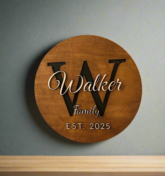 Wooden plaque with 'Walker Family EST. 2025' on a stone wall background